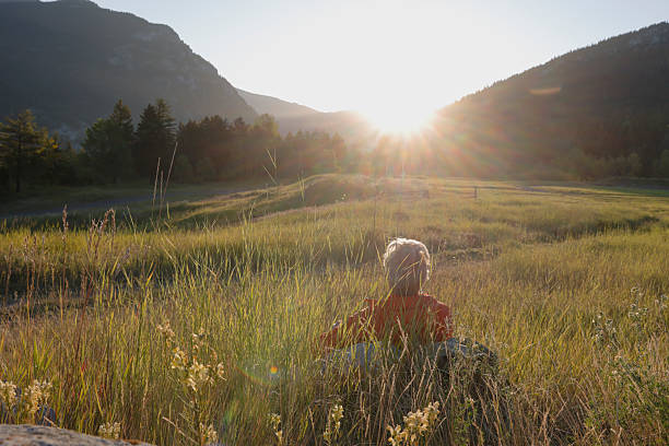 istock Mature man relaxes in mountain meadow at sunrise 2237010406