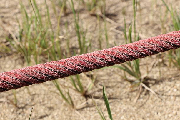 Rolled blue rope, rock climbing rope on ground . Close up view