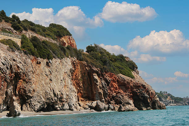 Mountainous sea coast with blue sky and clouds. Summer seascape.