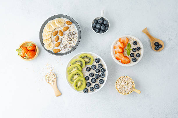 istock Oatmeal breakfast bowls with fruits and grains on white surface 2237014151