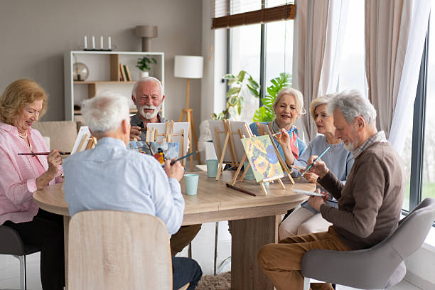 istock Elderly friends immersed in a painting session together 2237014672