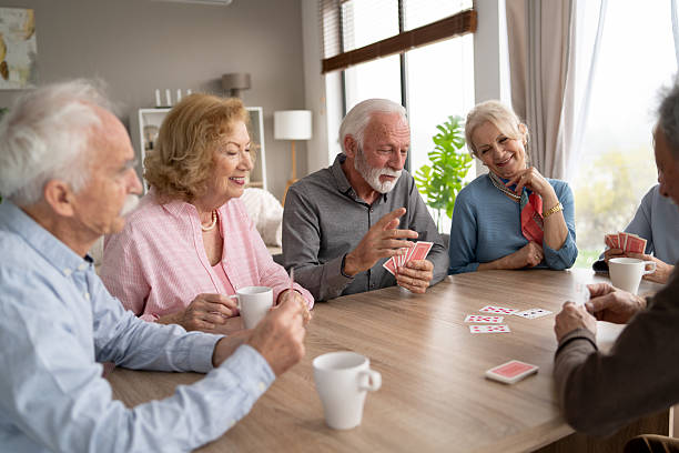 istock Seniors Enjoying a Fun Card Game Together in Bright Room 2237014701