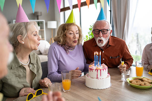 istock Seniors making wishes while blowing out birthday cake candles 2237014715
