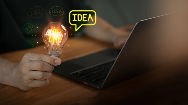 istock Male hand holding a glowing light bulb and 