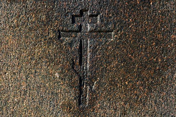 A close up of intricate carvings on a grey stone surface.