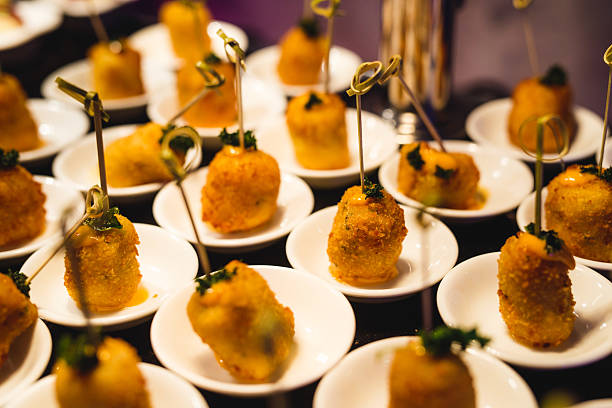 istock Gourmet Fried Appetizers with Herb Garnish on Small Plates 2237020036