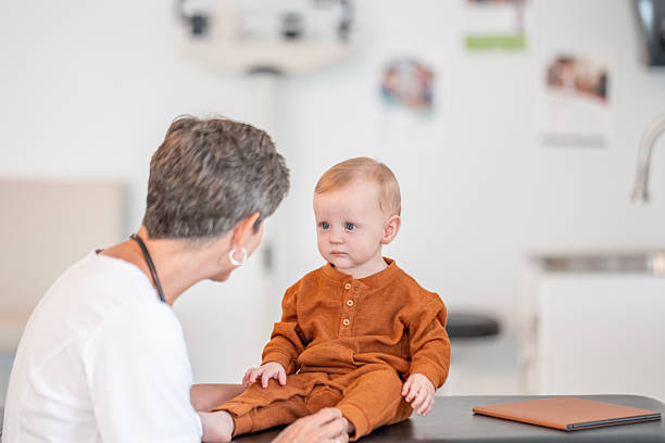 istock Caring Pediatric Nurse Interacts With Baby During Checkup In Bright Clinic Setting 2237022707
