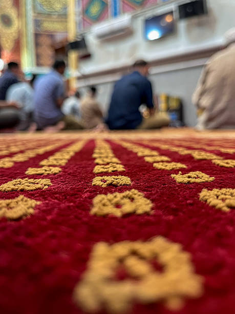 istock Muslim Worshippers Sitting on Red Carpet Inside Mosque 2237025608