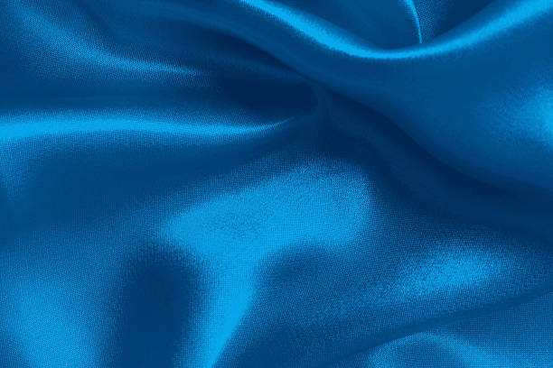 Blue fabric cloth texture for background and design art work, beautiful crumpled pattern of silk or linen.