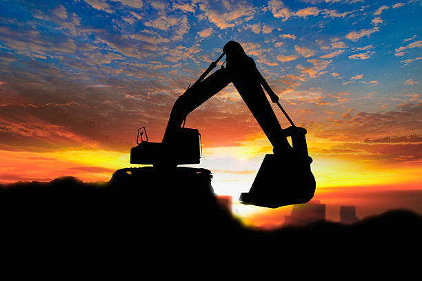 istock Crawler excavators silhouette are digging the soil . 2237037475