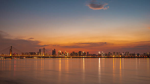 istock Dramatic sky and clouds with modern urban waterfront skyline during sunset 2237043745