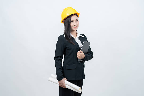 istock An Asian female engineer, standing confidently in a white background studio, holds a blueprint and places her laptop nearby as a symbol of her contributions to technology and industry. 2237043893