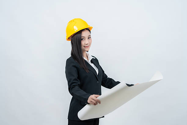 istock In a professional white background studio, the Asian female engineer examines a blueprint that highlights her role in the evolving industry, combining intelligence, skill, and vision. 2237043903