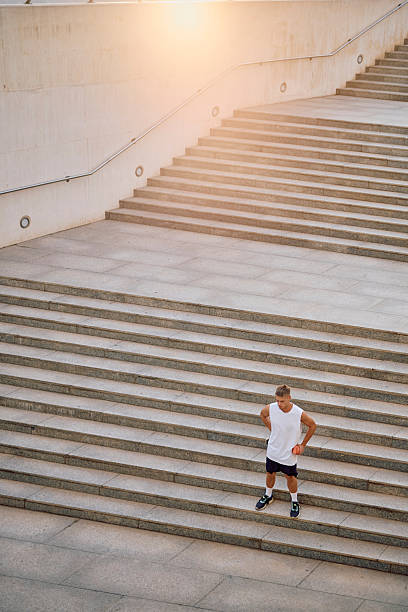 istock Urban athlete taking a break on concrete stairs 2237043954