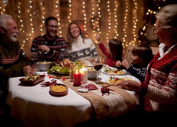 istock Cheerful extended family talking during Christmas dinner at home. 2237045422