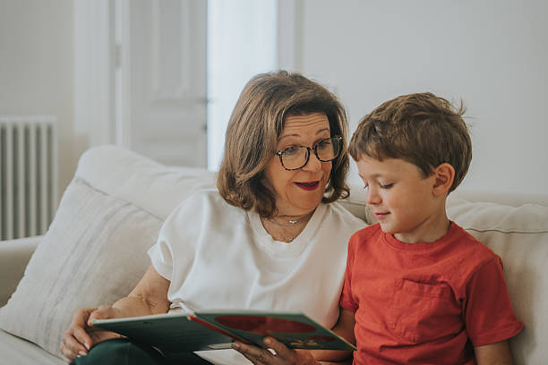 istock Woman reading a book to her grandson 2237050024