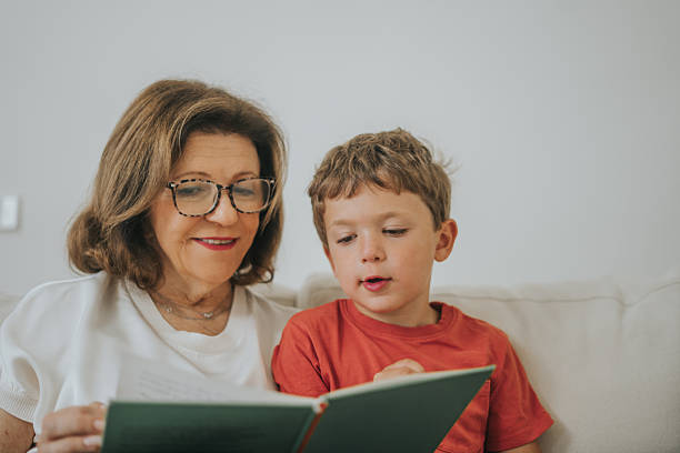 istock Woman reading a book to her grandson 2237050043