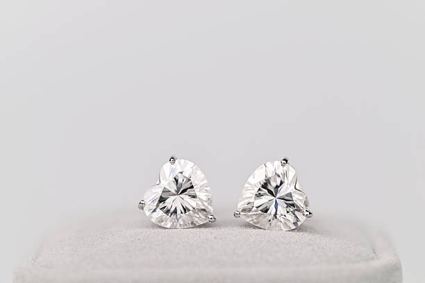 istock Two diamond earrings with a heart shape 2237050176