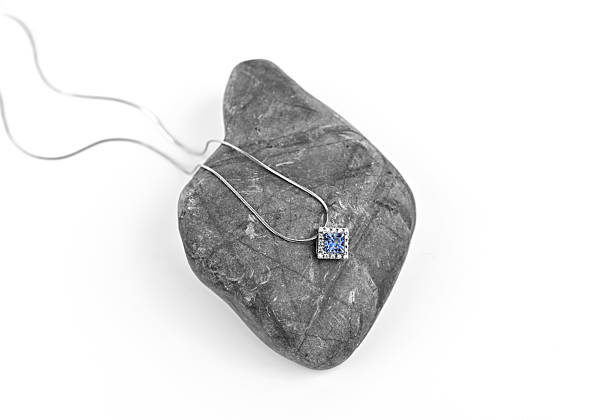 istock A blue diamond pendant is on a gray rock 2237050228