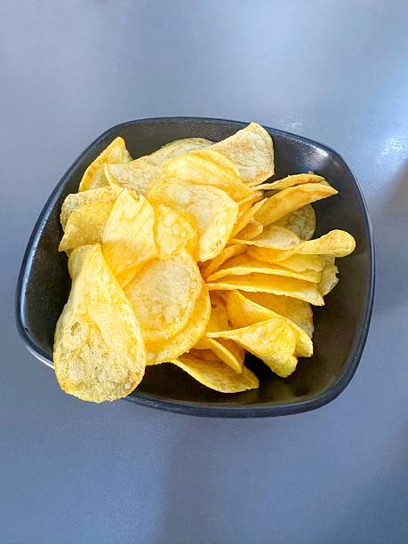Salted potato chips in a serving bowl