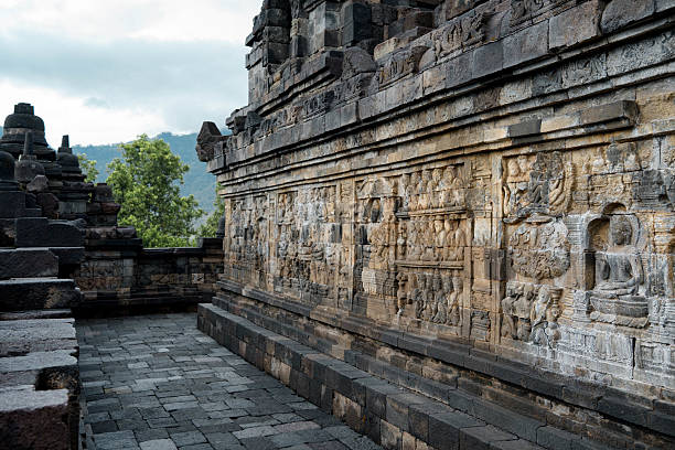 Singapore, Singapore - April 2, 2024. Historic carvings on wall along the trail in Fort Canning Park in Singapore