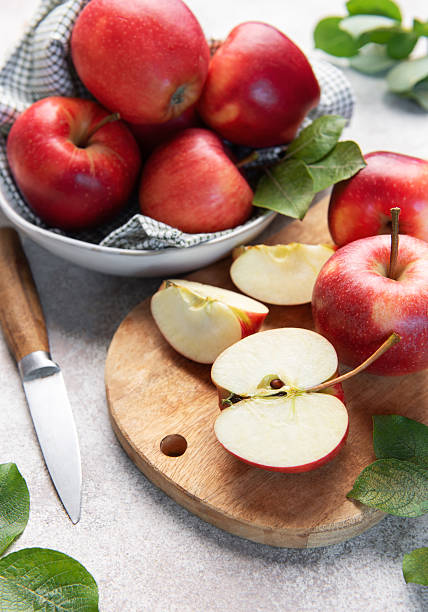 istock Red apples, whole and sliced, on cutting board 2237052719