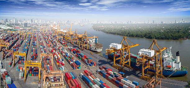 istock Logistics and transportation of Container Cargo ship and Cargo plane with working crane bridge in shipyard at sunrise, logistic import export and transport industry background 2237054067