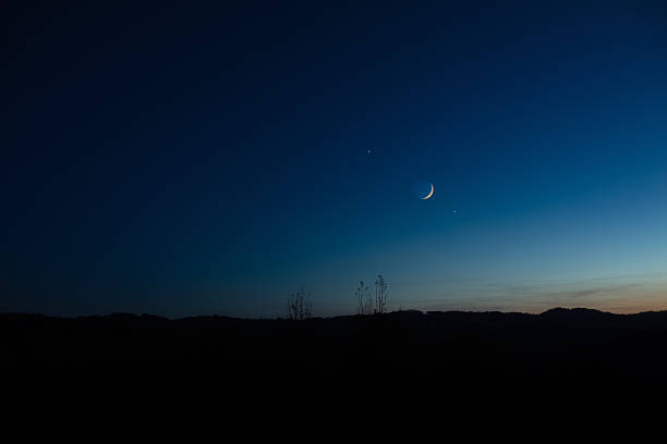 istock Crescent young Moon with stars, planets and countryside silhouettes. 2237054705