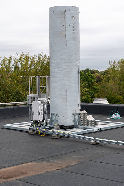 istock Modern 5G telecom infrastructure on rooftop, base station with antennas and cables.5G base station on building rooftop 2237055416