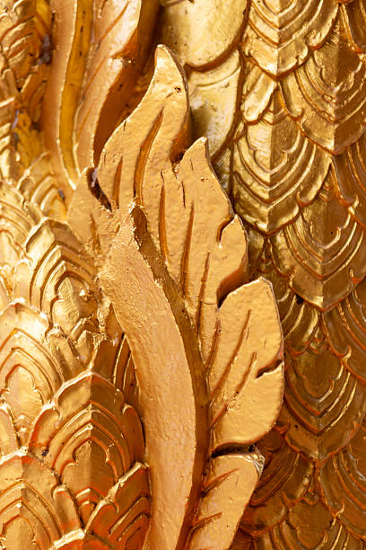 Carved floral pattern with golden wheat ears and leaves on white background.