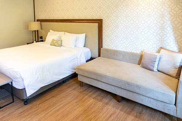 Clean bedroom interior in a modern hotel room with a comfortable bed and fresh bedding