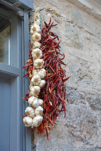 A close-up, vibrant shot of dried red chili peppers and other traditional dried vegetables on a rustic wooden table. This image captures the rich, authentic, and spicy flavors of Turkish and Middle Eastern cuisine, perfect for food-related content