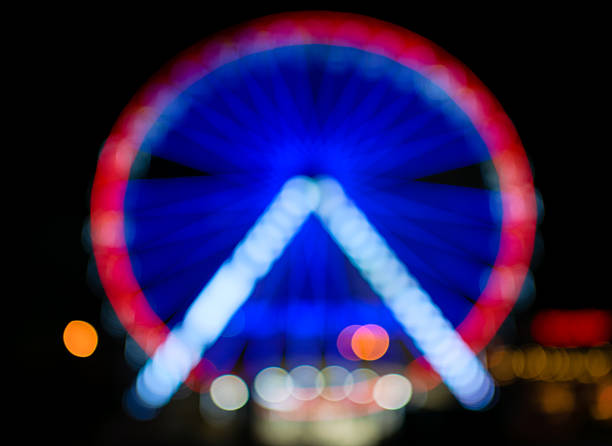 istock A blurred Ferris wheel illuminated with colorful lights. Background 2237065606