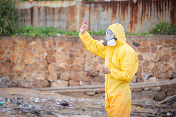 istock Researchers in Protective Gear Conducting Water Quality Tests, Environmental protection professional in a chemical suit, Scientist in a protective suit getting ready to hazardous zone 2237072561