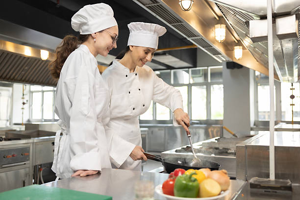 istock Woman Chef assisting a cooking class and explaining some tips and tricks 2237072571