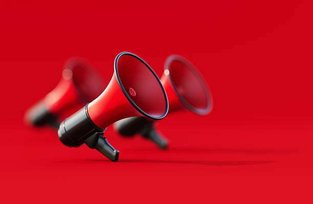 istock Black And Red Colored Megaphones On Red Background 2237073009