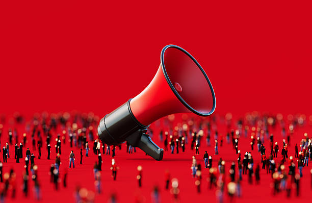 istock Black And Red Colored Megaphone Surrounded By Human Crowd On Red Background 2237073033