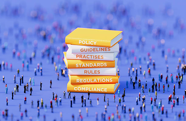 istock Yellow And White Compliance Books Surrounded By Human Crowd On Blue Background - Compliance Concept 2237074543