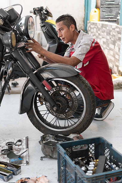 istock Mechanic repairing motorcycle in a workshop garage 2237075536