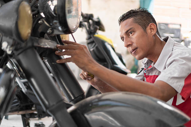 istock Mechanic repairing motorcycle in a garage 2237075715
