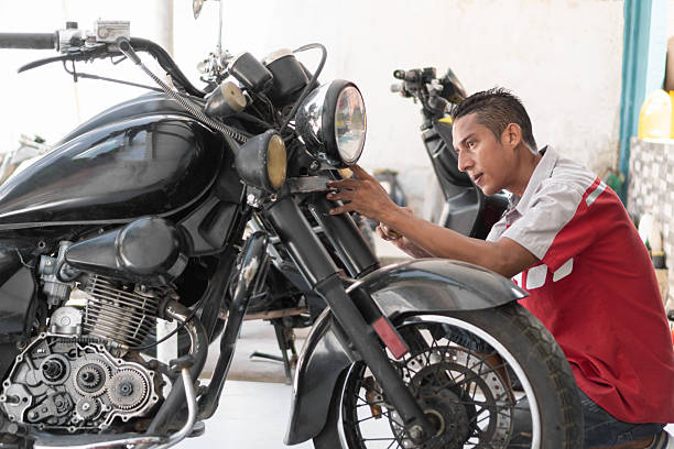 istock Mechanic repairing motorcycle headlight in garage workshop 2237075716