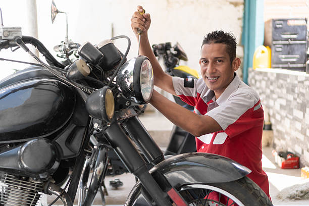 istock Smiling mechanic repairing motorcycle in a garage 2237076417
