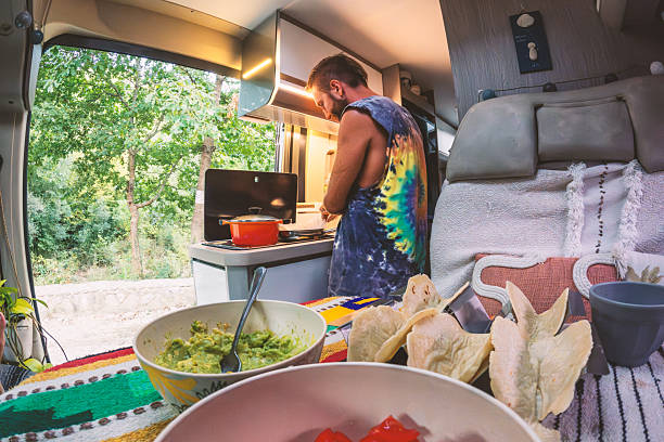 istock Man Cooking Tacos Inside Camper Van with Outdoor View 2237079405