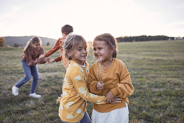 istock Children playing outdoors in a rural field at sunset 2237081379