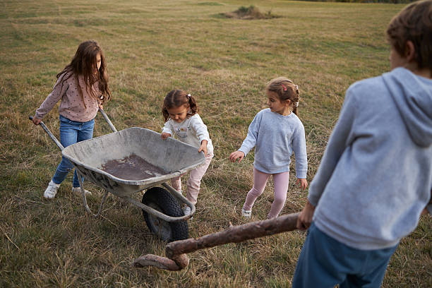 istock Children playing with wheelbarrow and stick outdoors, having fun 2237081633