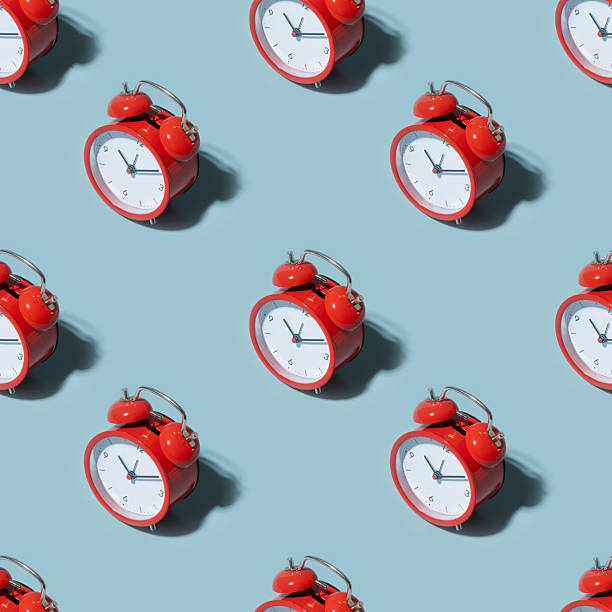 istock Seamless pattern of red alarm clock on blue background 2237083327