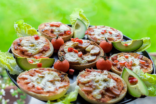 Mini Bagel Pizzas with Avocado, Brie, Ham, Cheddar and Cherry Tomatoes