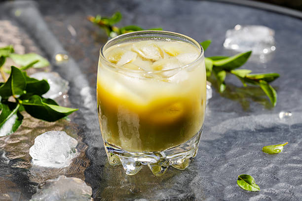 Refreshing Iced Matcha Latte with Ice and Leaves
