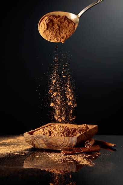 istock Cinnamon powder is poured into a wooden dish. 2237087047