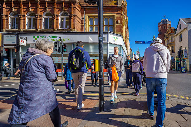 Exeter, UK. 23 September 2025. Shops and shoppers on the High Street in Exeter